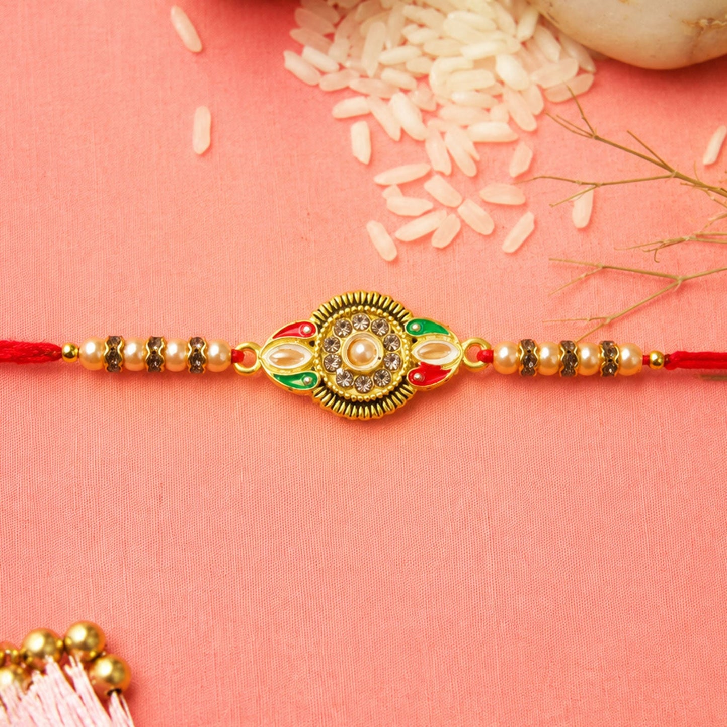 Side view of the round floral designer Rakhi featuring kundan stone embellishments.