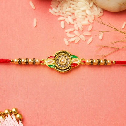 Side view of the round floral designer Rakhi featuring kundan stone embellishments.