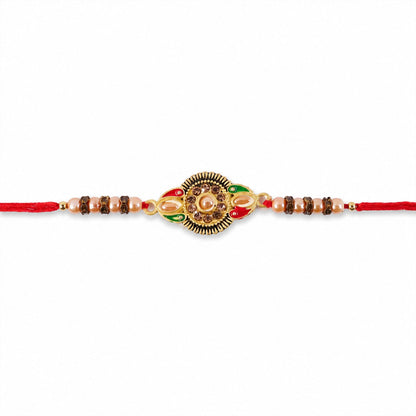 Round floral designer Rakhi for brother displayed with its clear packaging.
