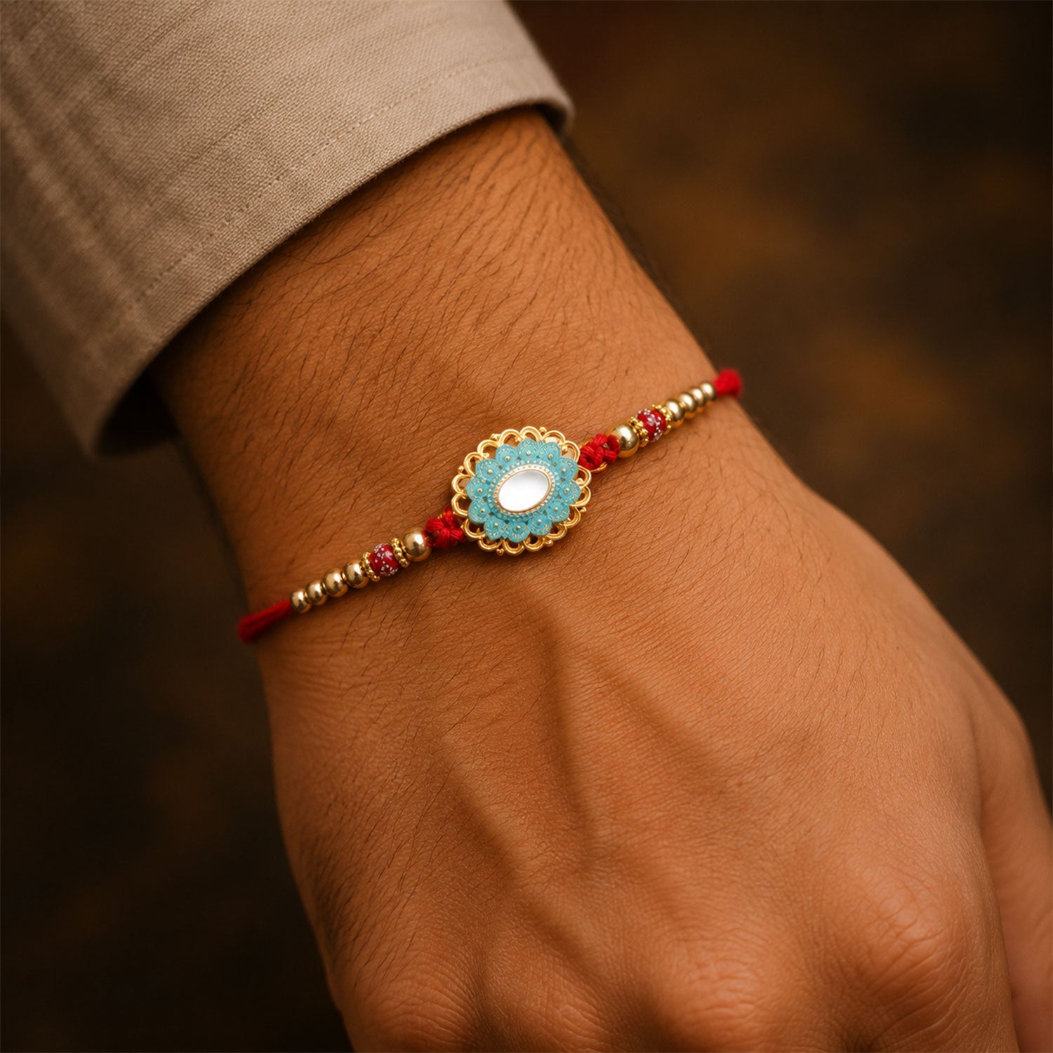 Side view of the elegant Round Kundan Rakhi with decorative pearl accents and thread.