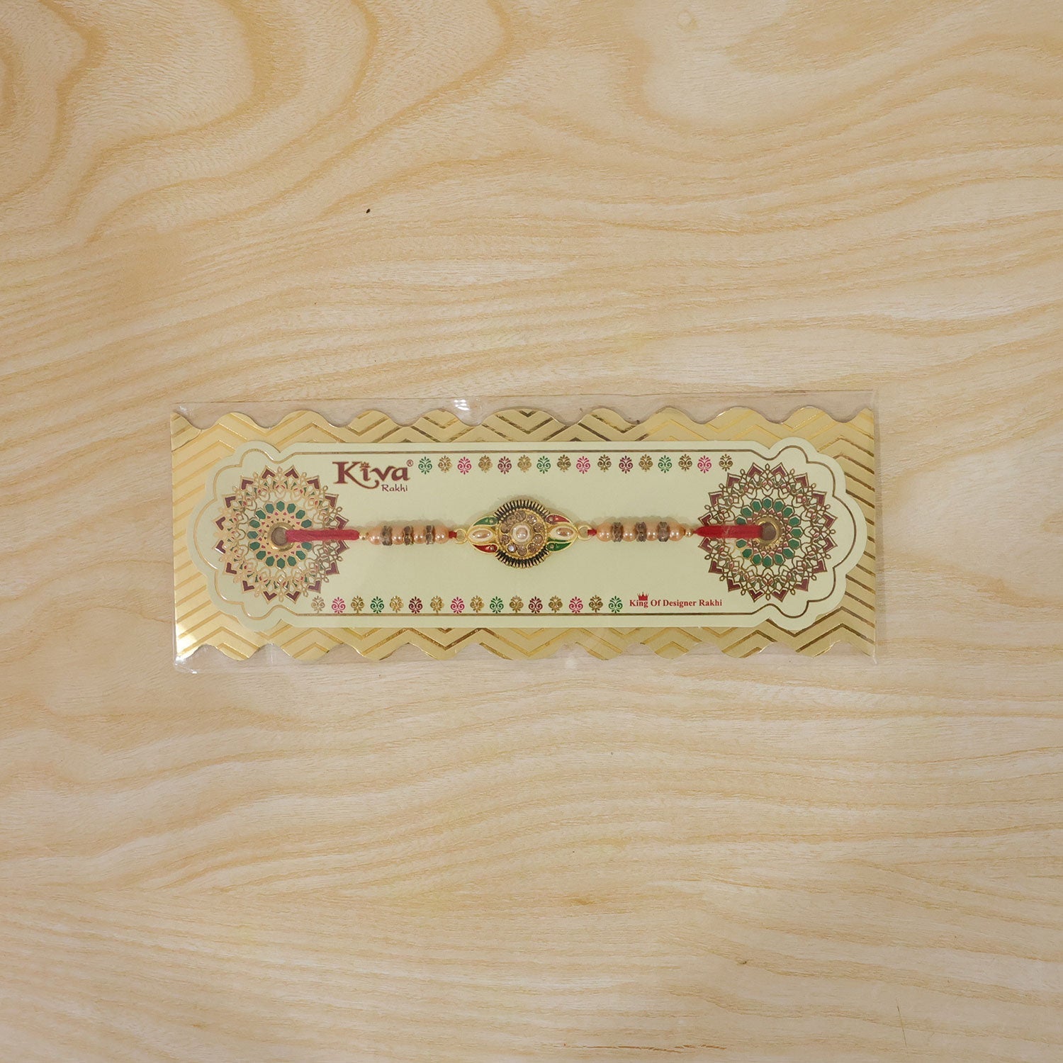 Hand wearing floral center designer rakhi with stone work