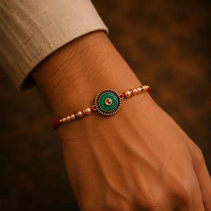 Elegant Kundan Rakhi for Brother with a round centerpiece and intricate thread work.