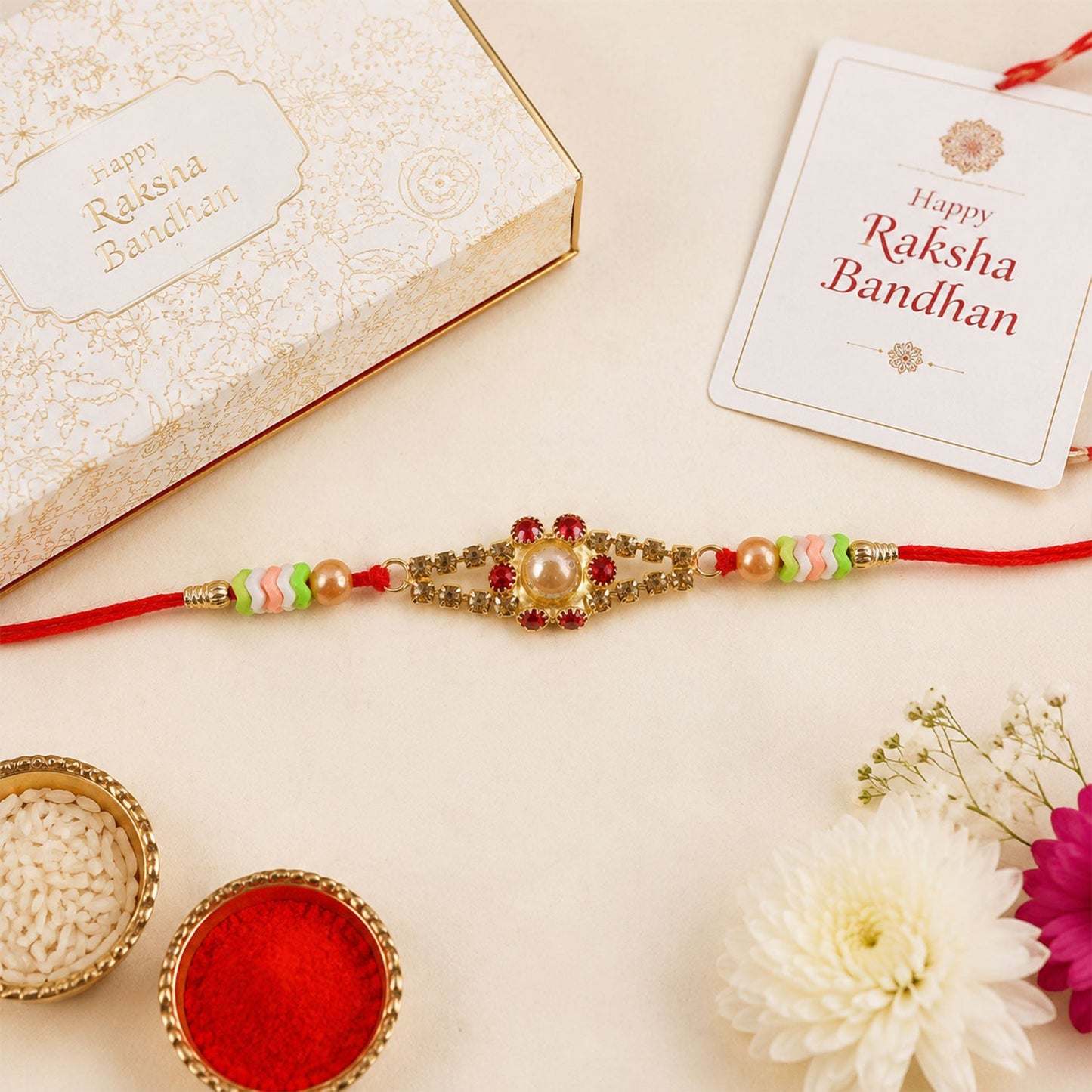 Pearl stone rakhi for brother displayed on a traditional thali.