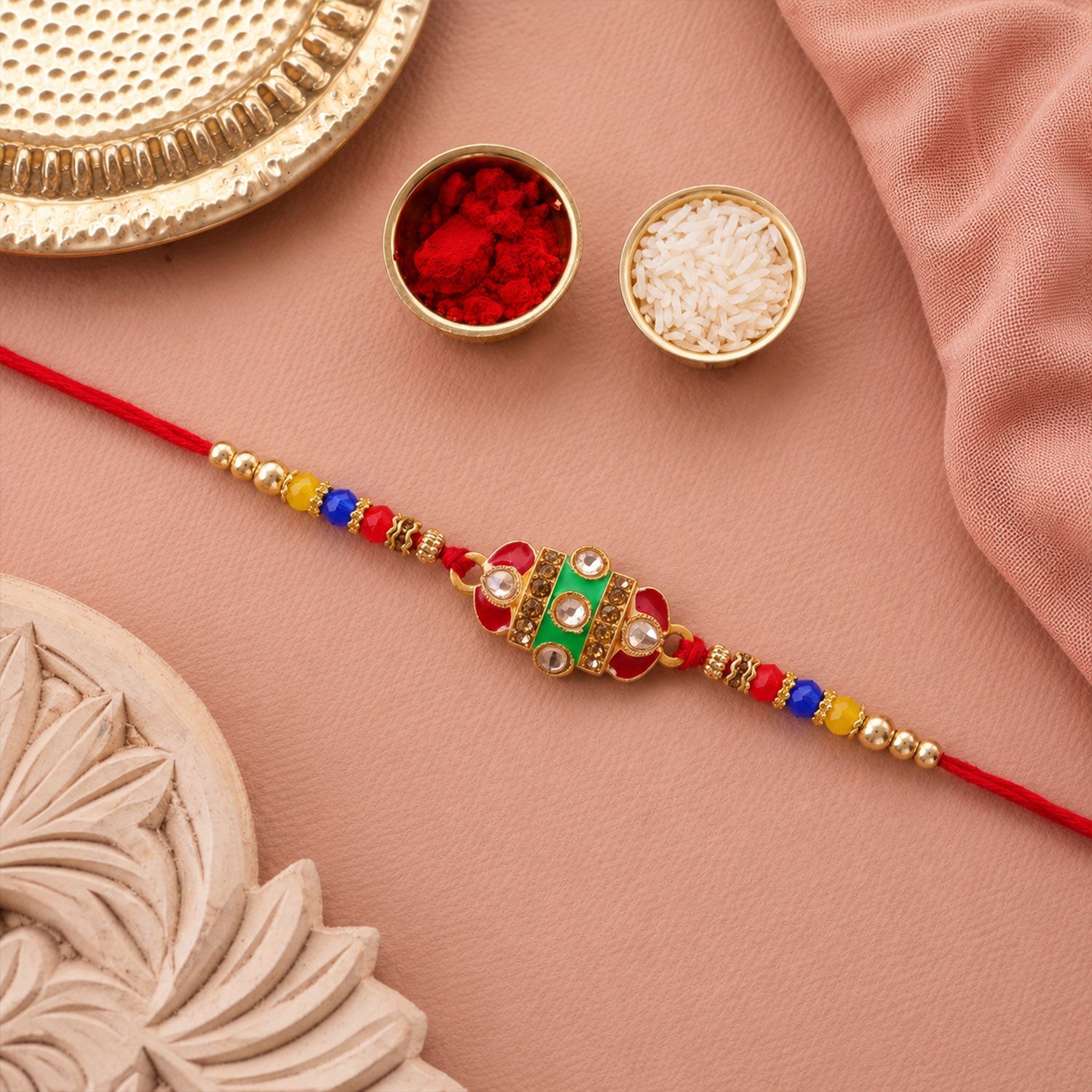 A pair of designer Kundan Rakhis with Meenakari work, ideal for brothers.
