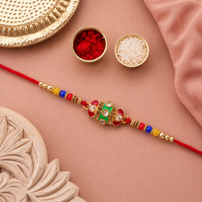 A pair of designer Kundan Rakhis with Meenakari work, ideal for brothers.