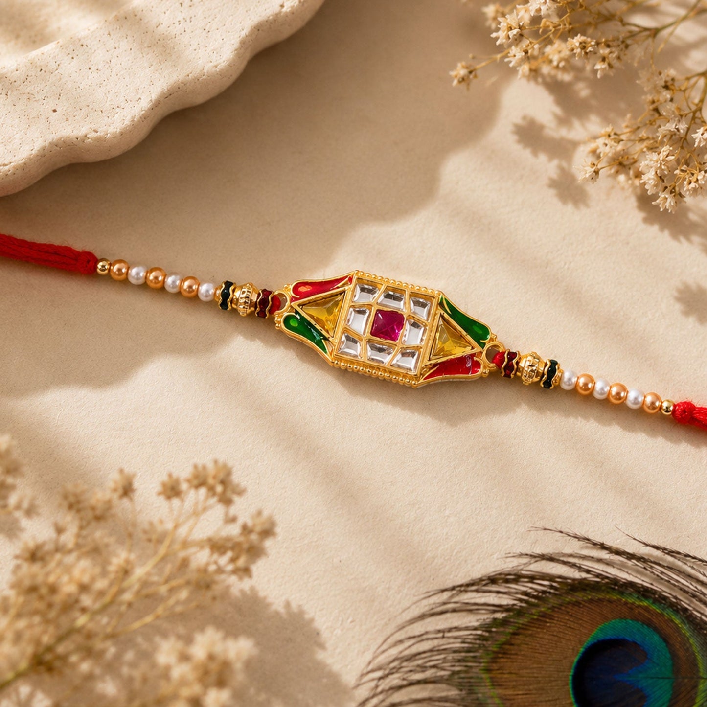 Close-up of the intricate diamond charm design on the Rakhi thread.