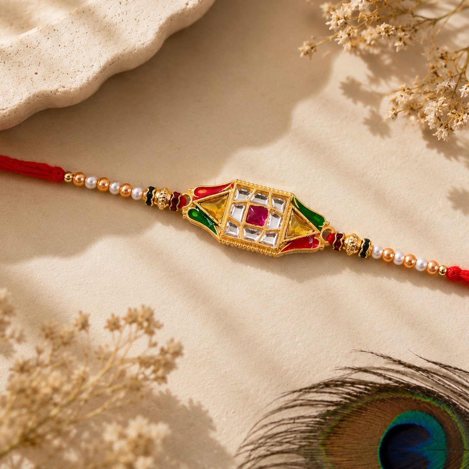 Close-up of the intricate diamond charm design on the Rakhi thread.