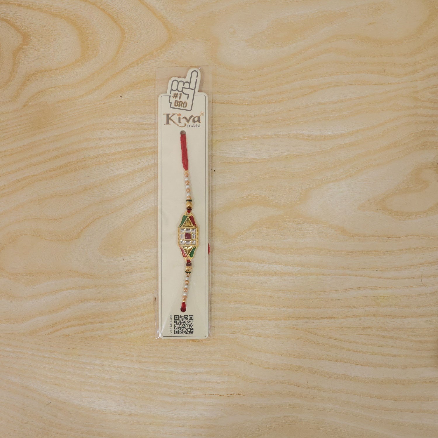 Full view of the Rakhi thread and charm, showcasing its overall design.