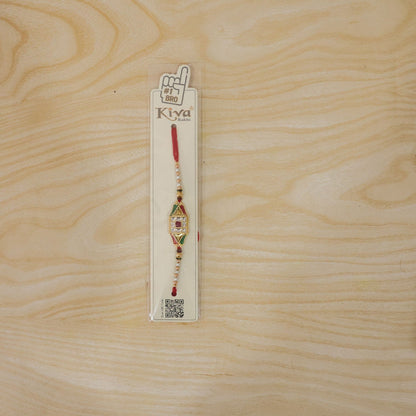 Full view of the Rakhi thread and charm, showcasing its overall design.