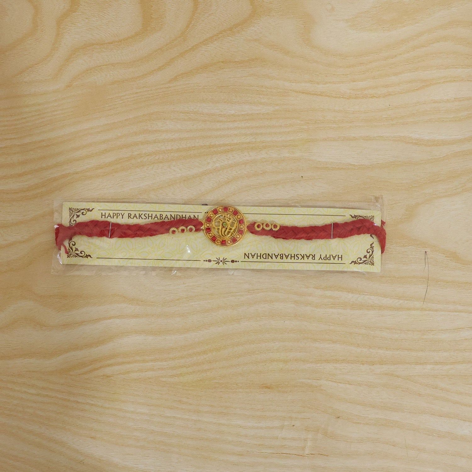 Divine Ganesha Round Rakhi with Stone Studded Border Rakhi for Brother