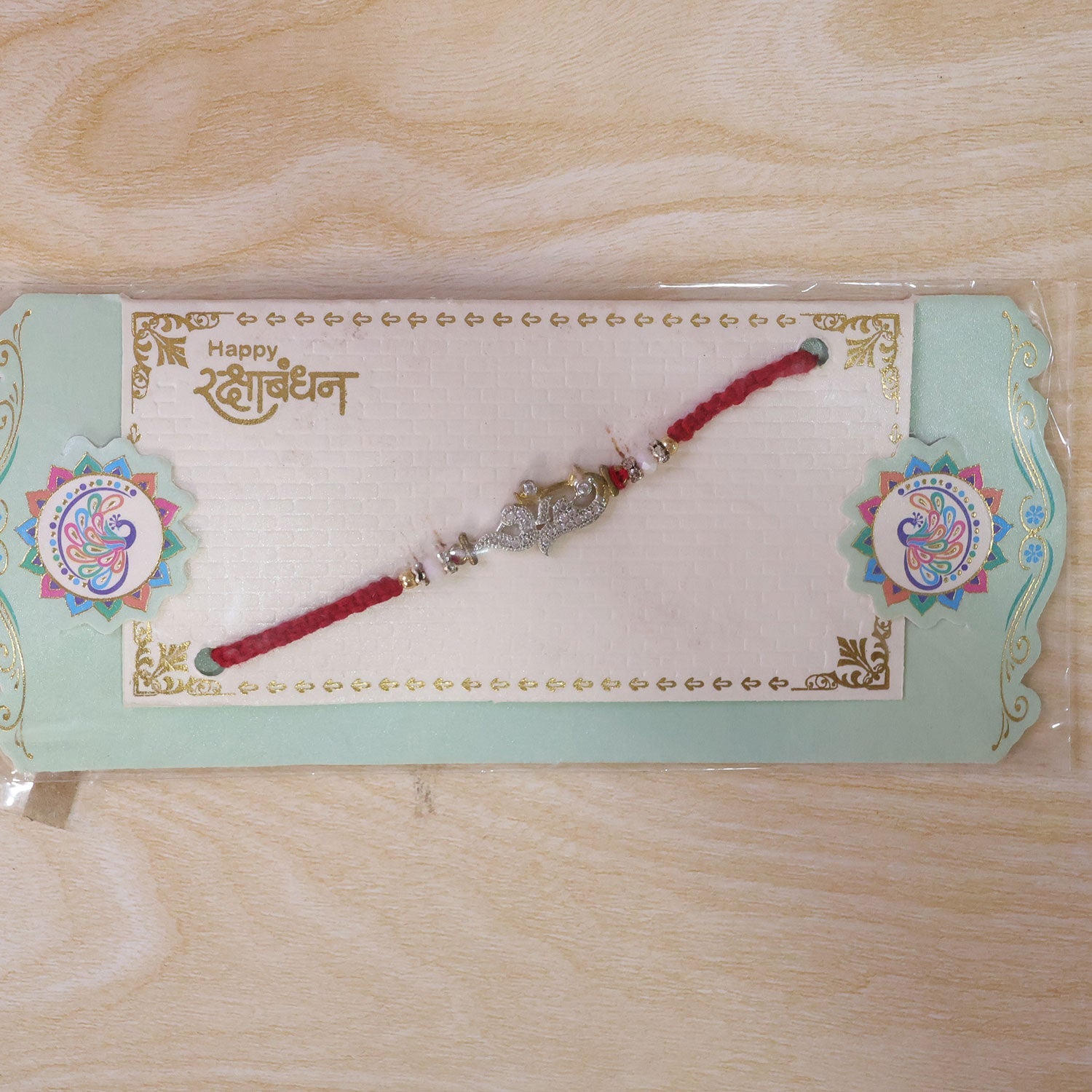 Religious Om Peacock Diamond Rakhi with Beadwork Rakhi for Brother