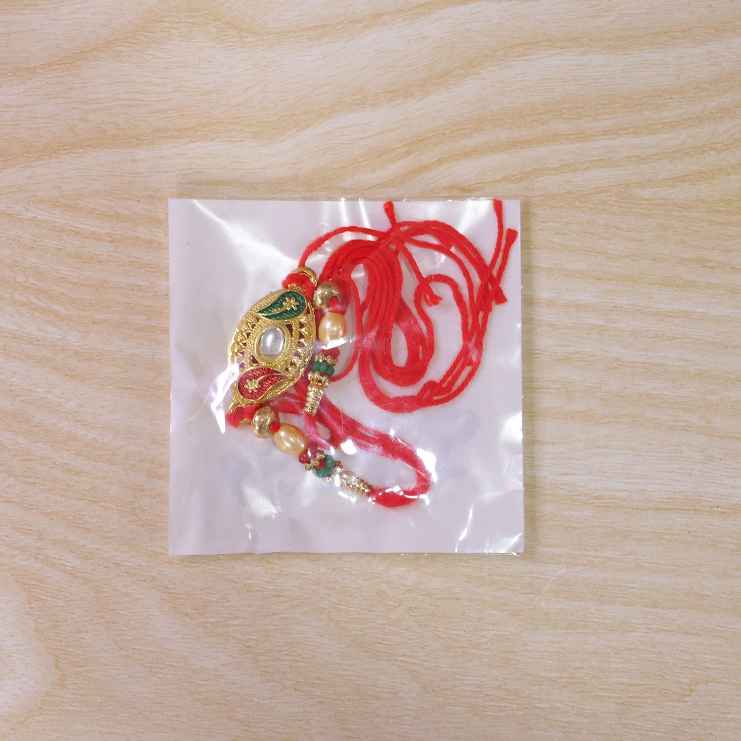 Golden Kundan Oval Rakhi with Meenakari & Pearls – Rakhi for Brother
