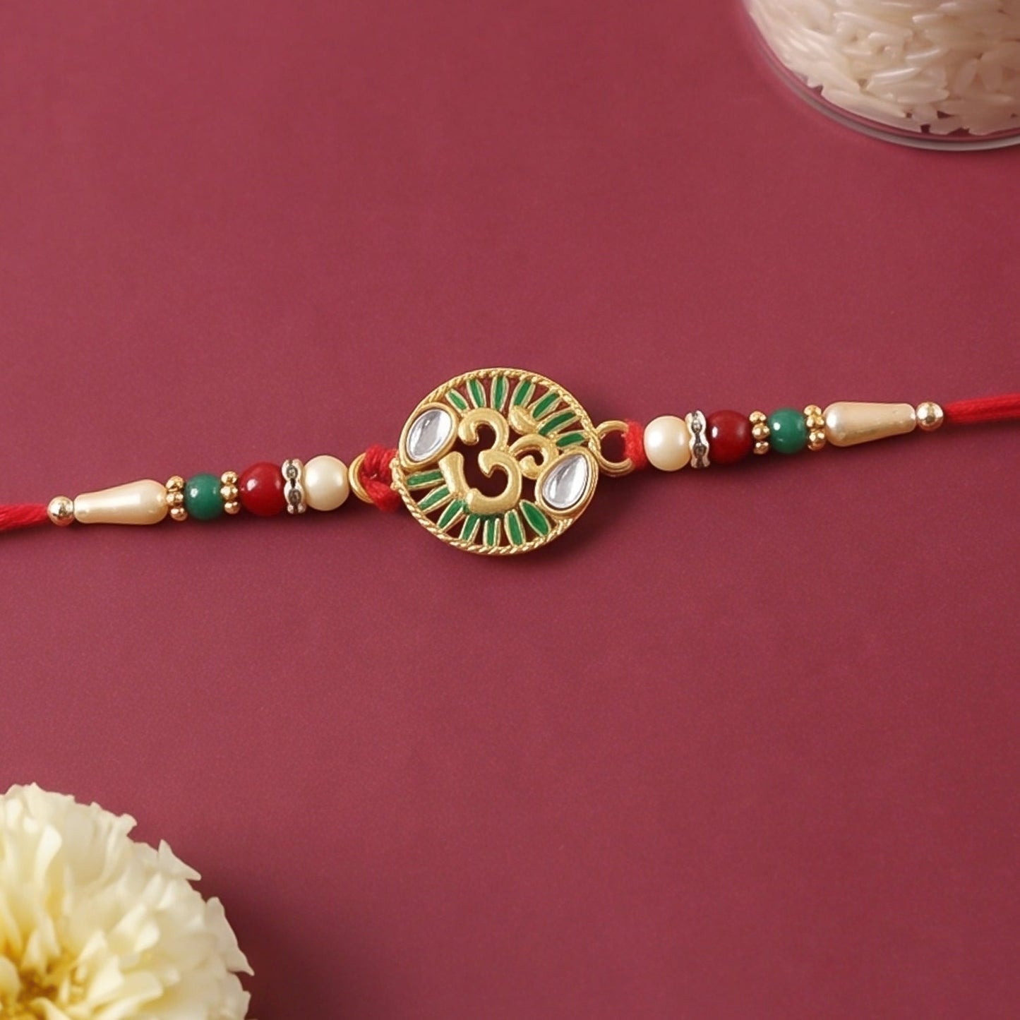 Om stone studded designer rakhi tied on a brother's wrist during Raksha Bandhan festival.
