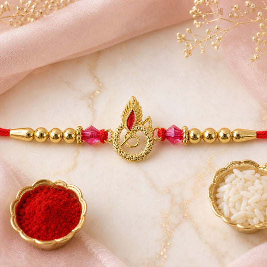 Charming Designer Rakhi Showcasing a Gold Motif, Pink Crystals and Glossy Beads