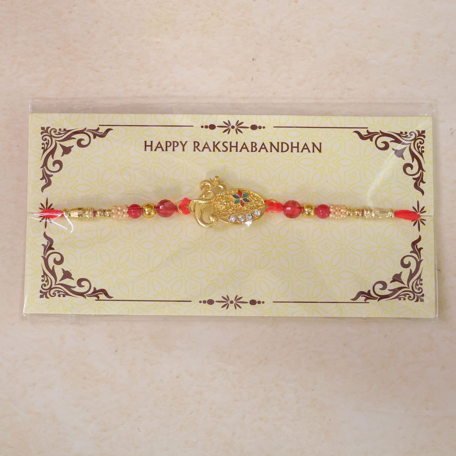 Stylish Om Shape Kundan Designer Rakhi with Beaded Festive Detail