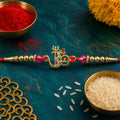 Om Charm Designer Rakhi with Pearl Beaded Traditional Styling