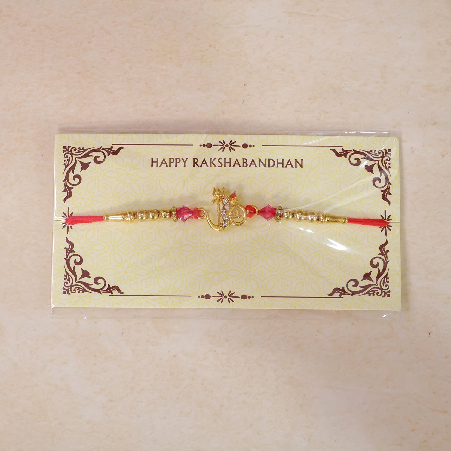 Om Charm Designer Rakhi with Pearl Beaded Traditional Styling