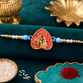 Leaf Shape Radha Krishna Designer Rakhi with Pearl Beaded Festive Detailing