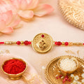 Round Om Coin Designer Rakhi with Stone Beaded Festive Detail