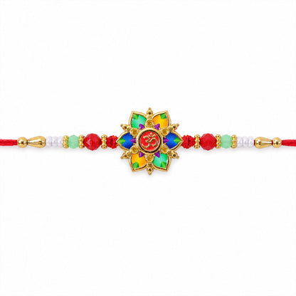 The multicolor lotus and Om design, with red, green, and white beads on a red thread, is presented on a plain white