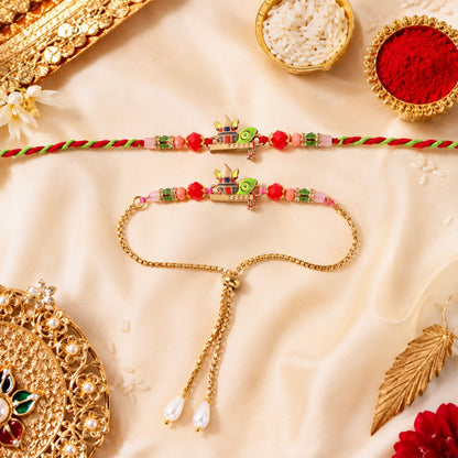 The Kalash motif bracelet set, featuring red and green beads, is arranged on a cream silk cloth with decorative elements.