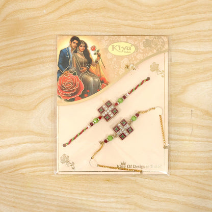 A pair of red and green beaded bracelets with square floral centers, one on a braided string and the other on a gold chain,
