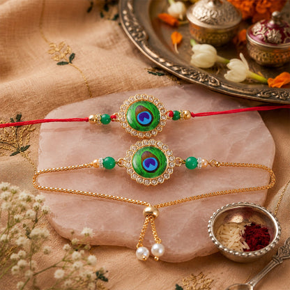 Two peacock feather design bracelets on a pink marble slab with a silver tray and small bowls.