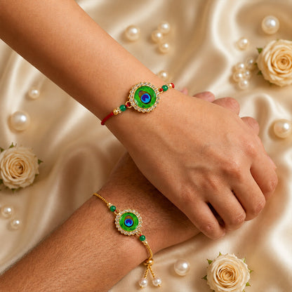 Two hands wear peacock feather design bracelets, one on a red thread, the other on a gold chain.