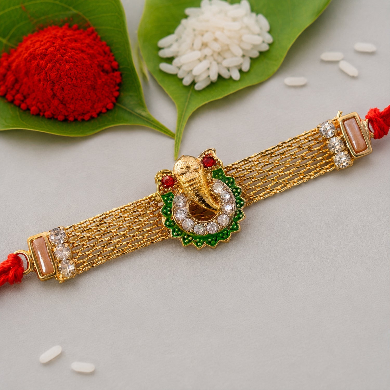 Ganesha Charm Rakhi with Elegant Stone Center Motif Design