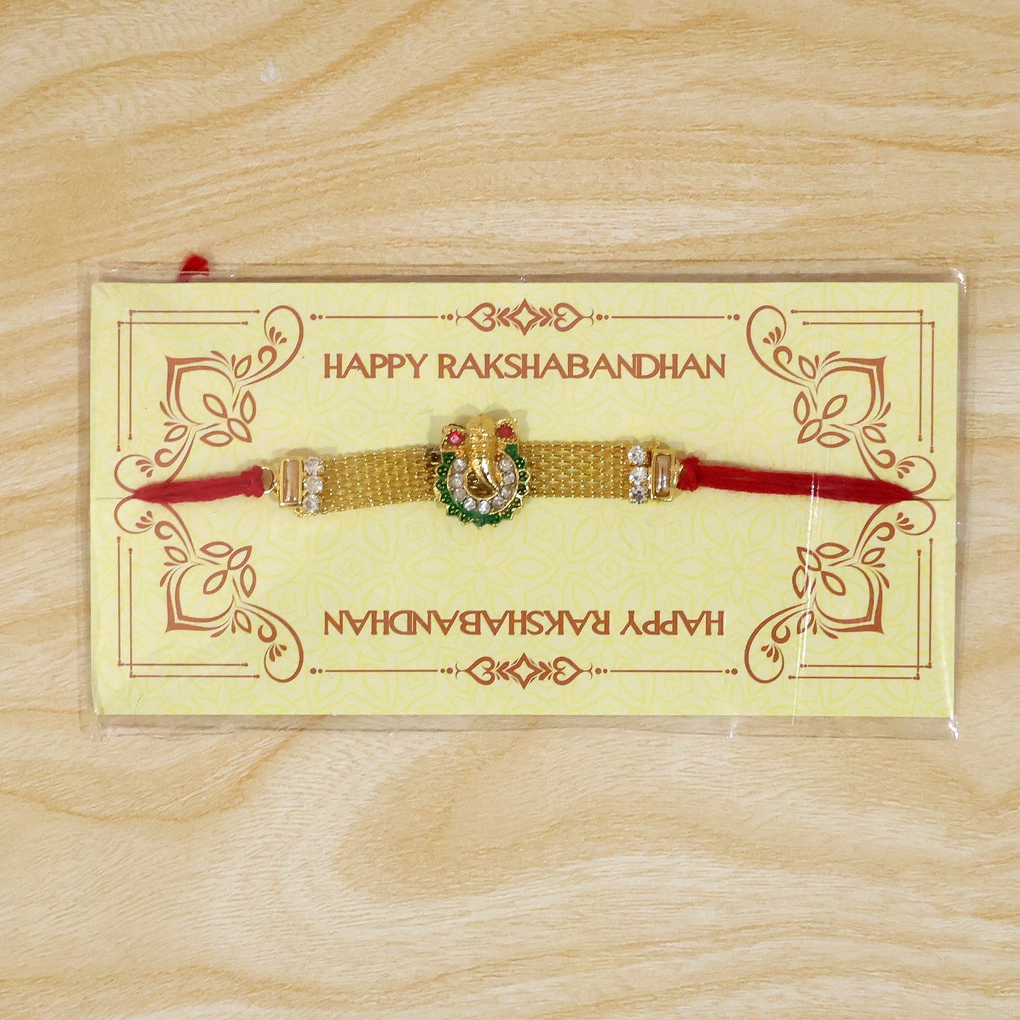 Ganesha Charm Rakhi with Elegant Stone Center Motif Design