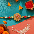 Om Floral Kundan Rakhi with Pearl Beads and Traditional Motif Design