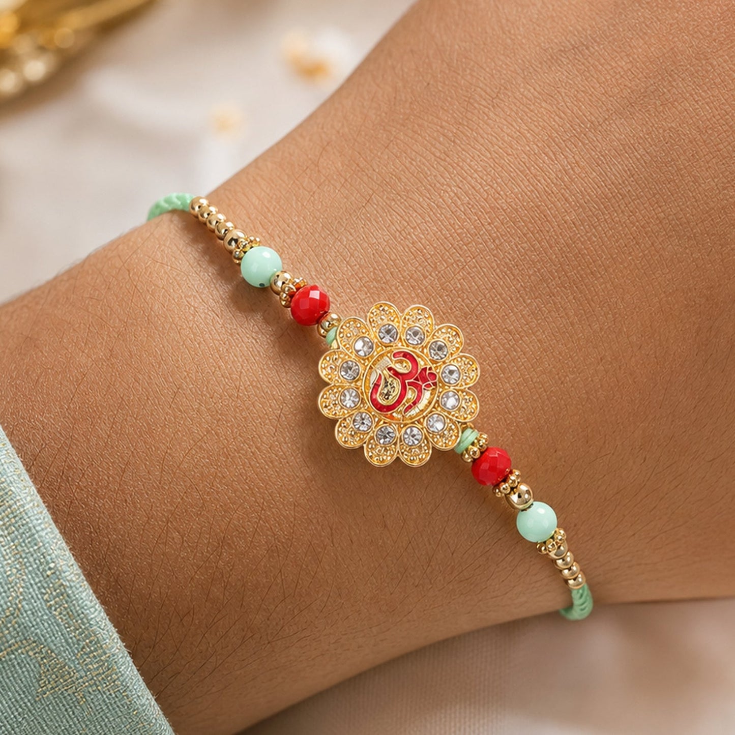 Om Floral Kundan Rakhi with Pearl Beads and Traditional Motif Design