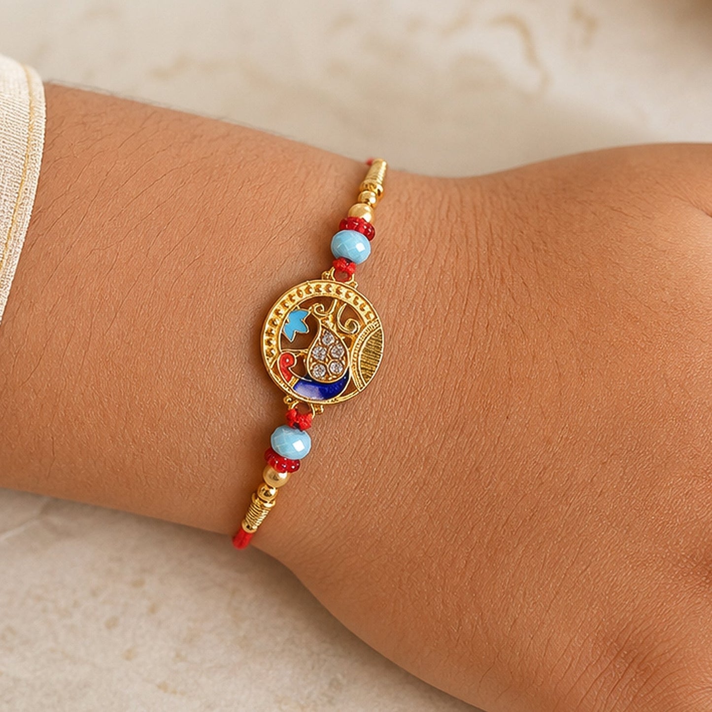 Round Peacock Motif Rakhi with Beaded Sacred Center Charm Design