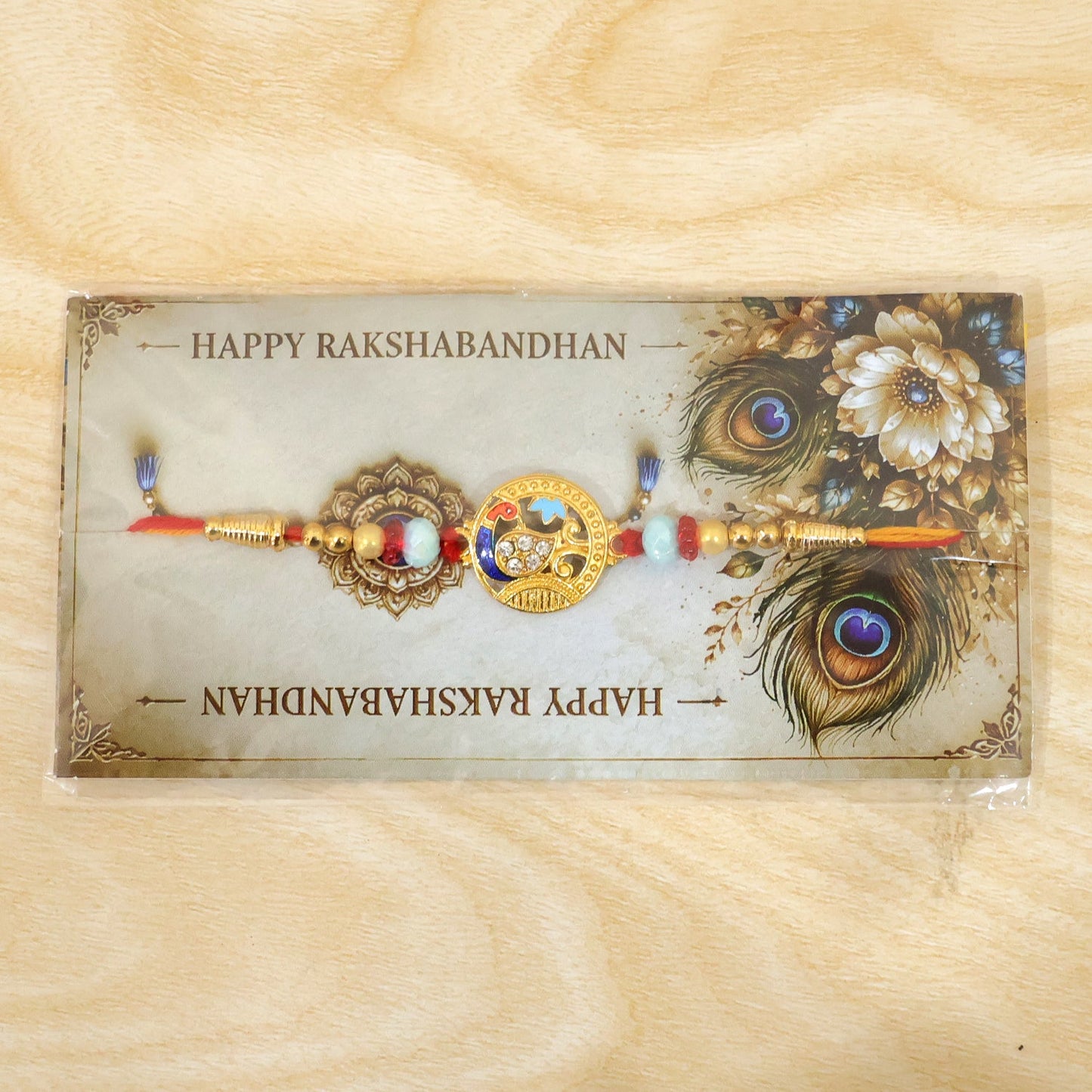 Round Peacock Motif Rakhi with Beaded Sacred Center Charm Design