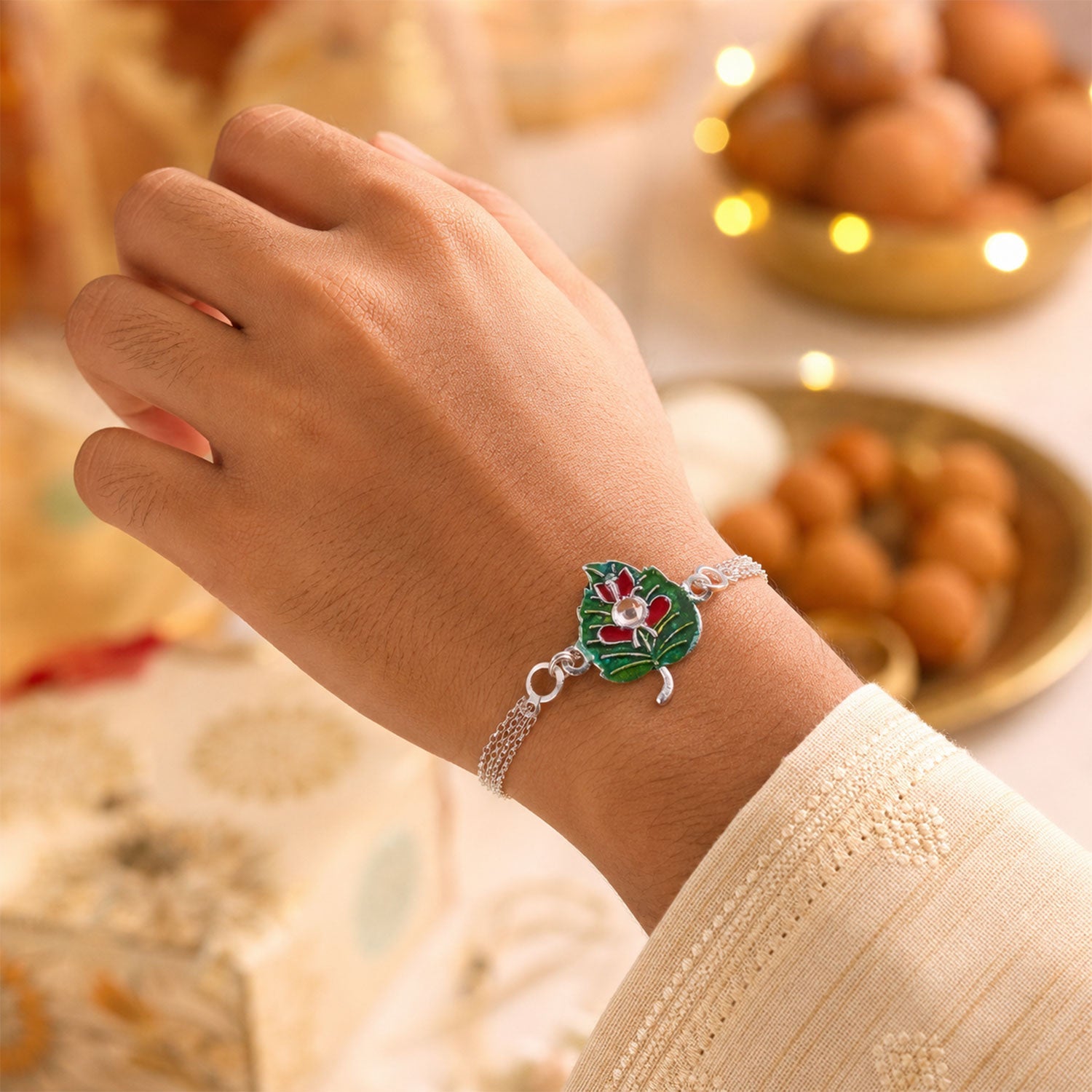 Leaf Ganesha Motif Stone Rakhi with Elegant Chain Center Detail Design