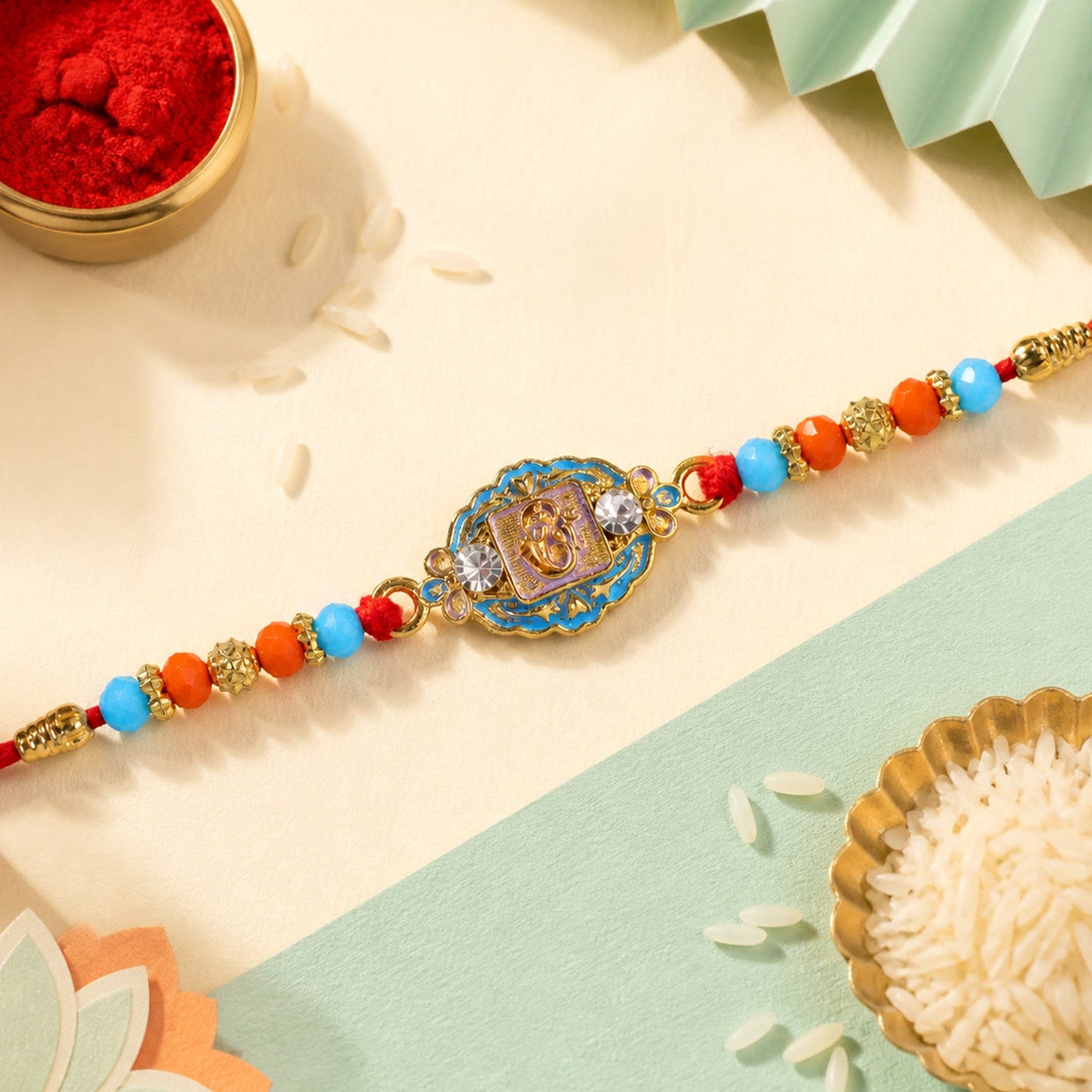 Round Ganesha Motif Stone Rakhi with Pearl Beads and Sacred Center Detail
