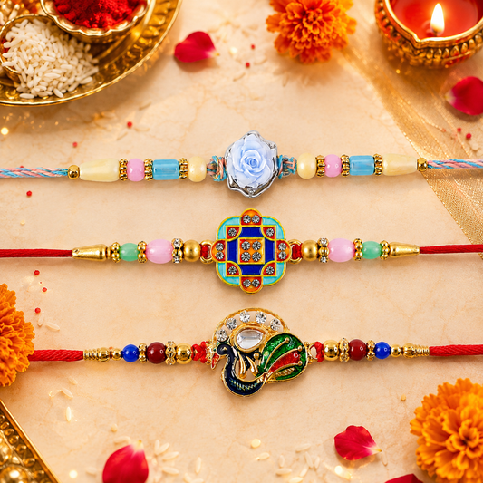 Three colorful bracelets with gold beads and charms, including a blue rose, a geometric square, and a peacock, lie on a