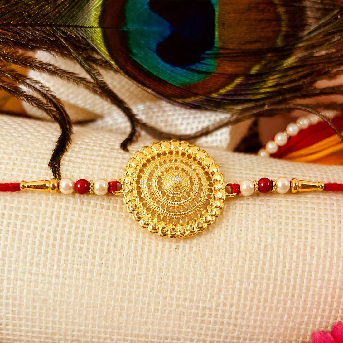 Stylish Ganesha Chain, Gold Pearl Round & Om Peacock Rakhi for Brother (3 Pc Set)