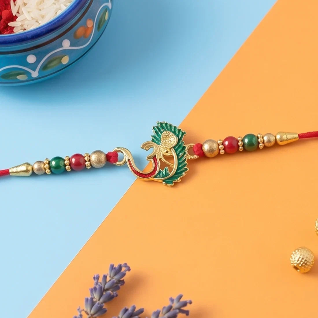 Stylish Ganesha Chain, Gold Pearl Round & Om Peacock Rakhi for Brother (3 Pc Set)