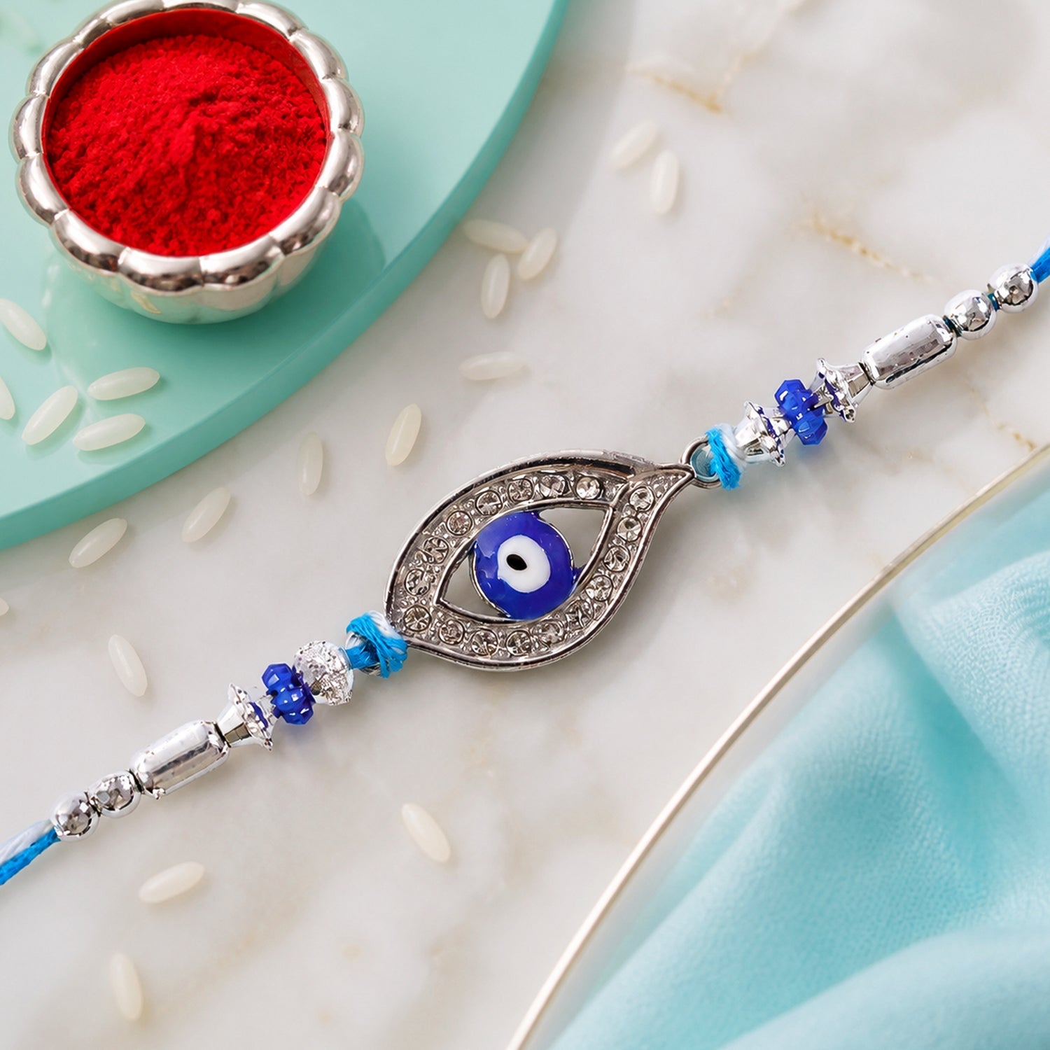 Evil Eye Rakhi with Studded Charm – Blue Crystal Beads