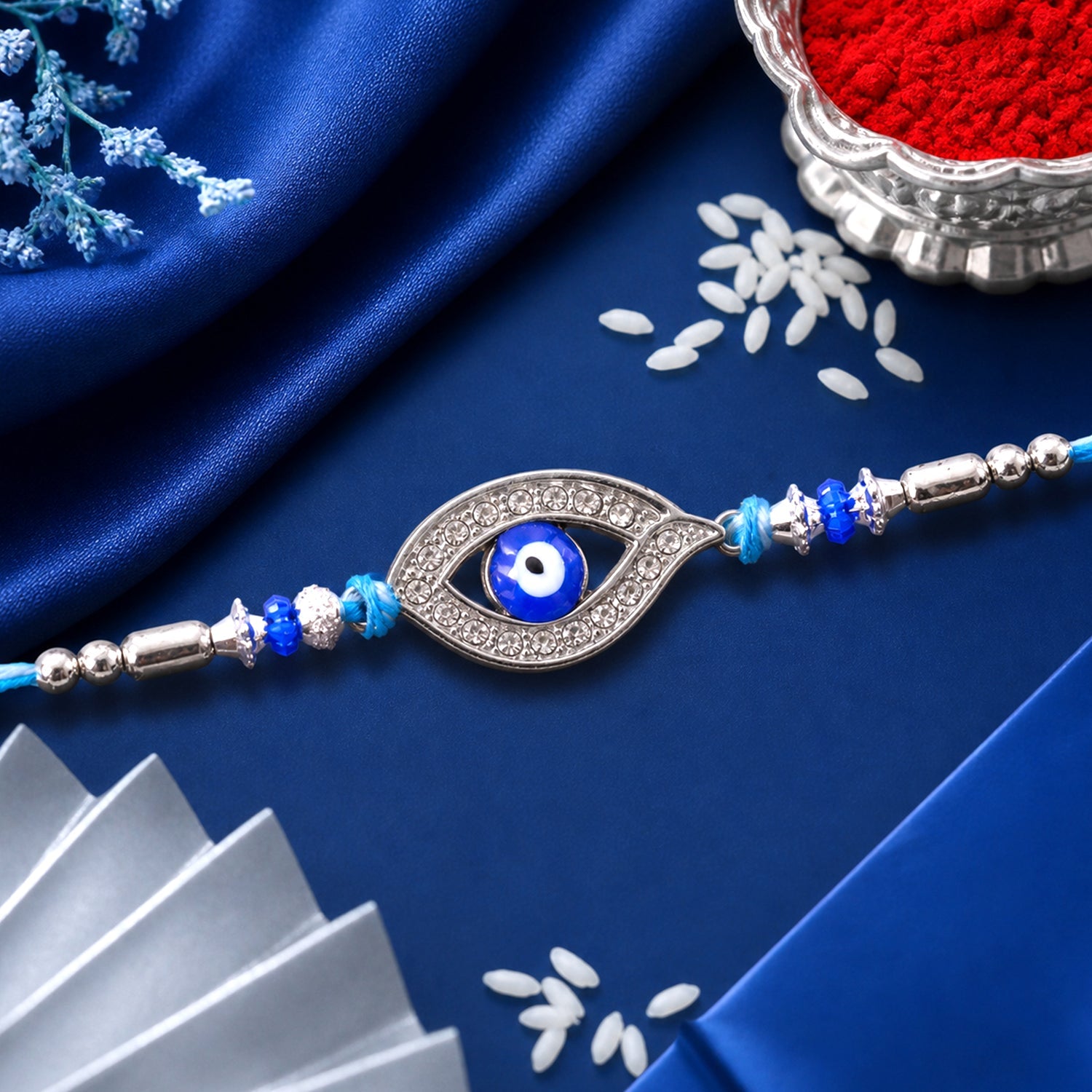 Evil Eye Rakhi with Studded Charm – Blue Crystal Beads