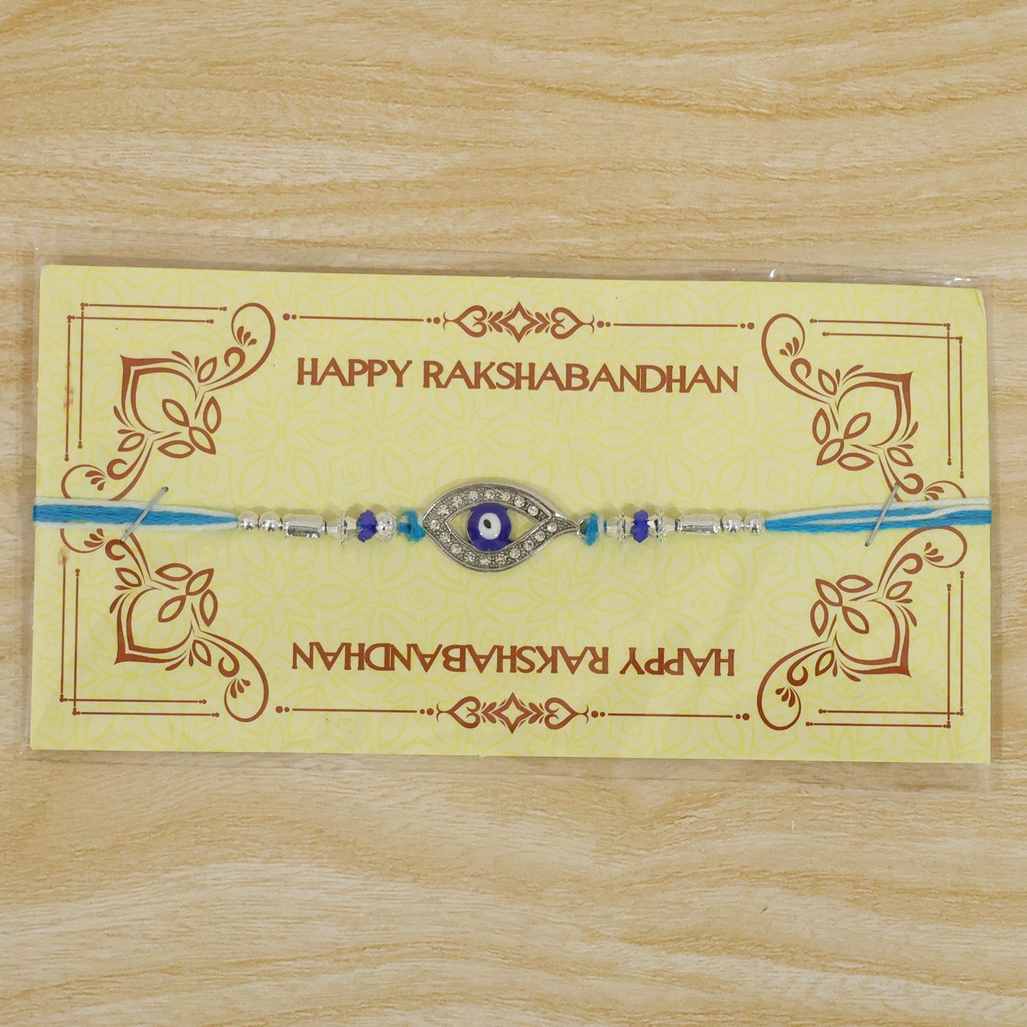 Evil Eye Rakhi with Studded Charm – Blue Crystal Beads