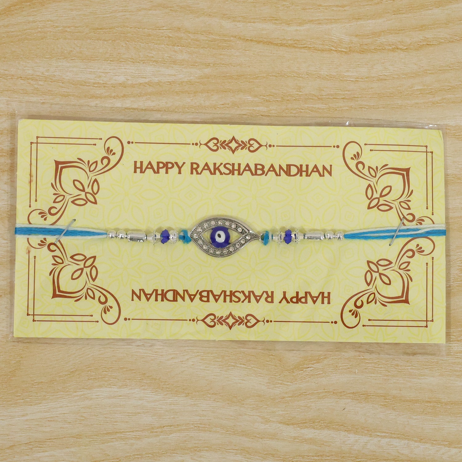 Evil Eye Rakhi with Studded Charm – Blue Crystal Beads