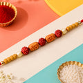 Stylish Om Charm Rudraksha Rakhi with Pearl & Sandalwood Beads