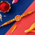 Divine Om Designer Rakhi with Golden Beads for Brother