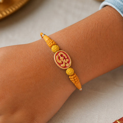 Divine Om Designer Rakhi with Golden Beads for Brother