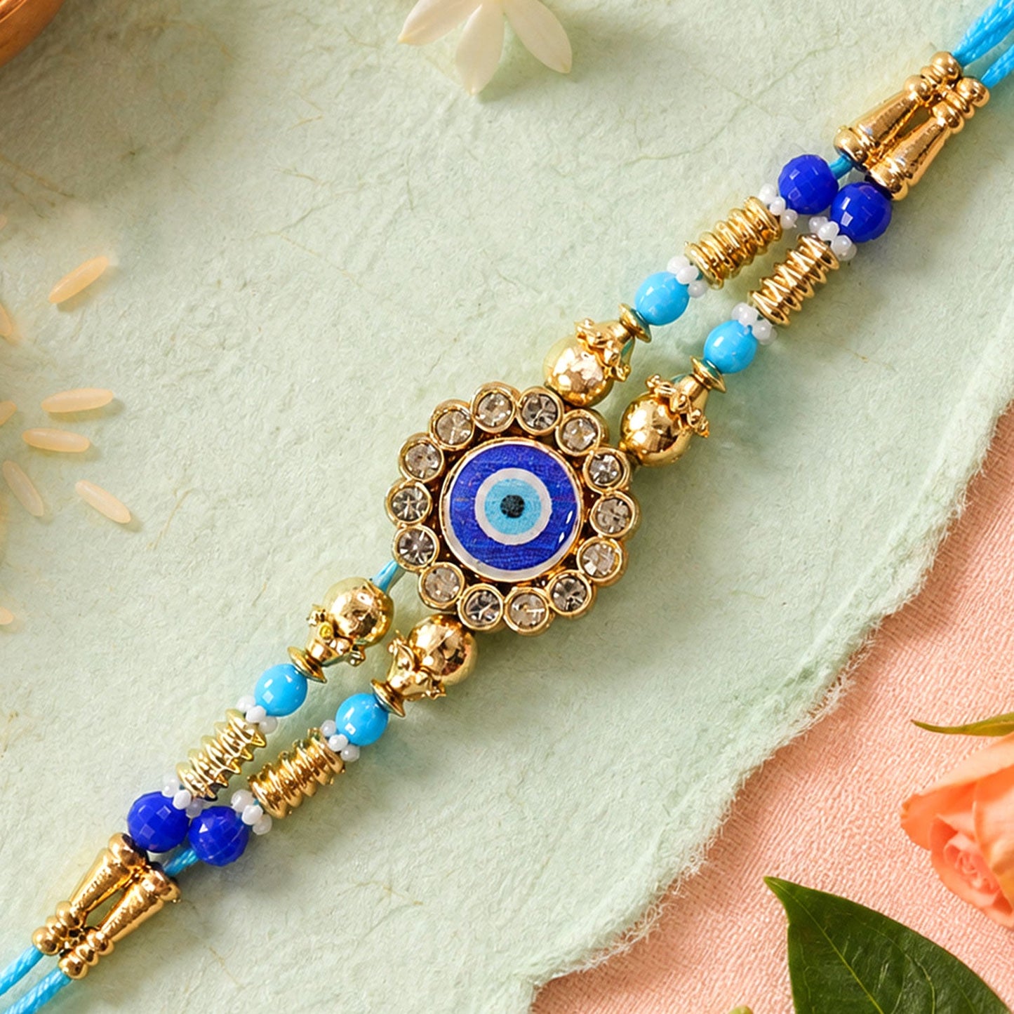Round Evil Eye Kundan Rakhi with Pearl Beads and Ornate Center Design