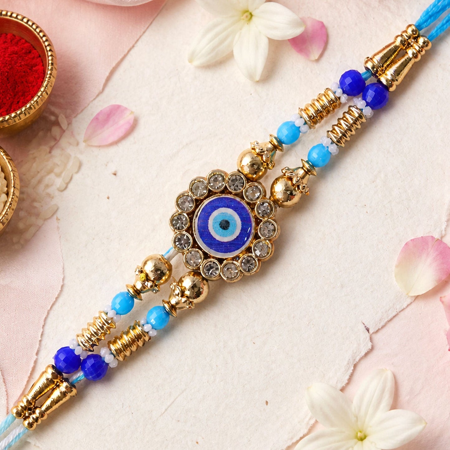 Round Evil Eye Kundan Rakhi with Pearl Beads and Ornate Center Design
