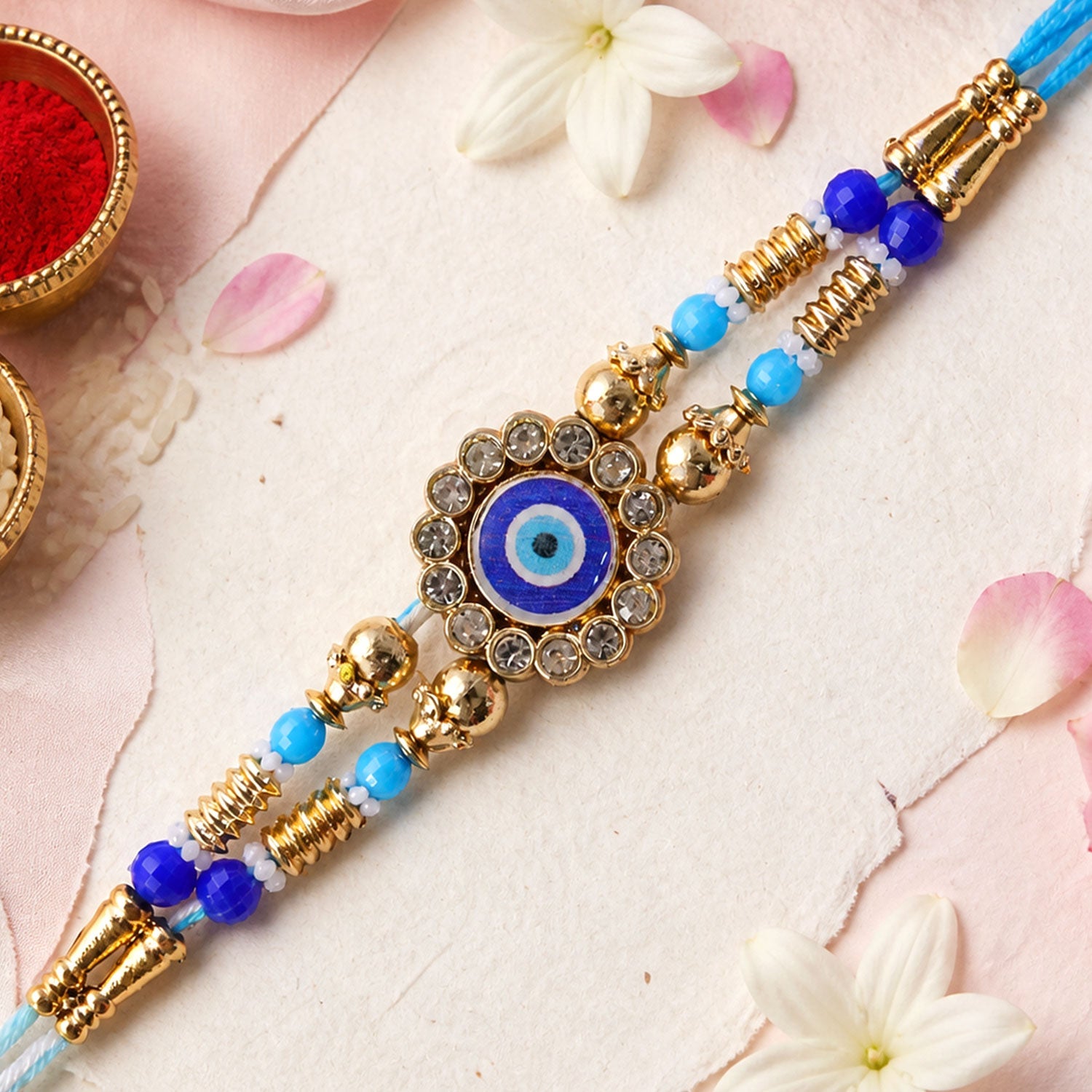 Round Evil Eye Kundan Rakhi with Pearl Beads and Ornate Center Design