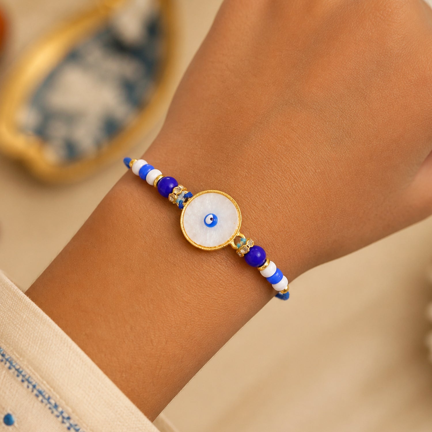 Classic Evil Eye Rakhi with Pearl Beads and Smooth Round Center Detail